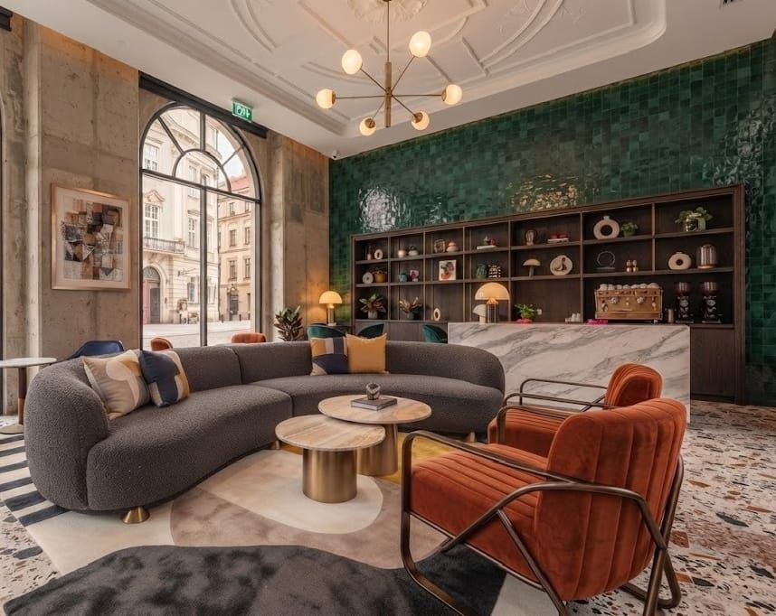 Hotel lounge with curved sofa and velvet armchairs